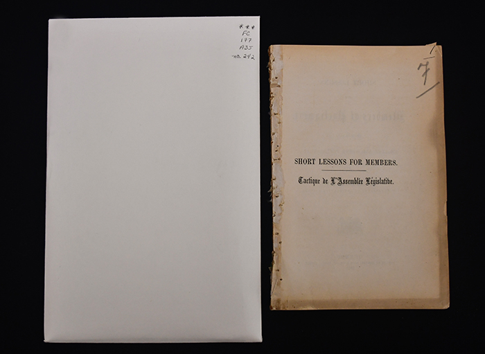 A large envelope and old stained pages on a black surface