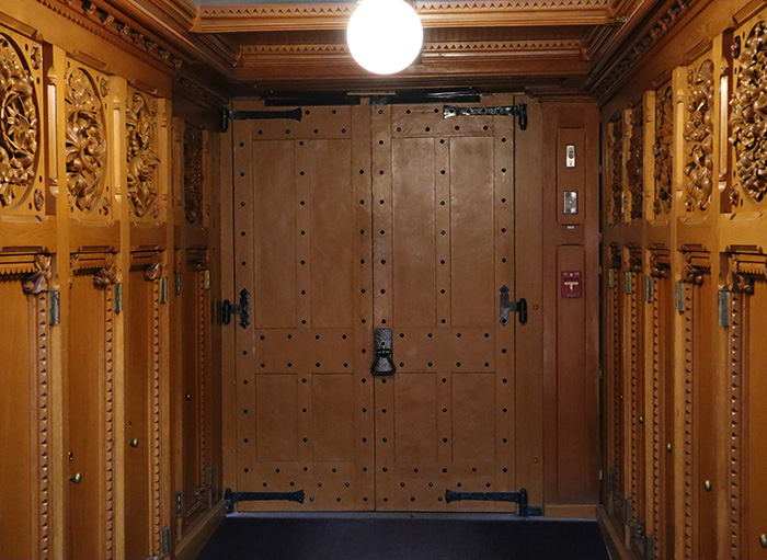 Portes de fer et sculptures sur bois qui recouvrent les murs de chaque côté.