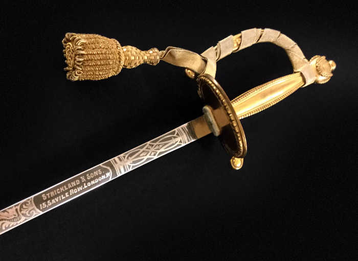 Civilian Dress Uniform: sword is made of silver with a D-guard handle made of a metallic material