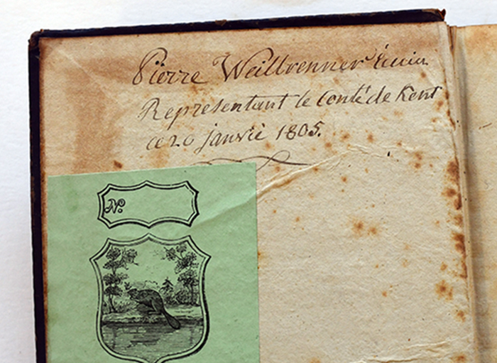 inscription in ink on the inside cover of an old book