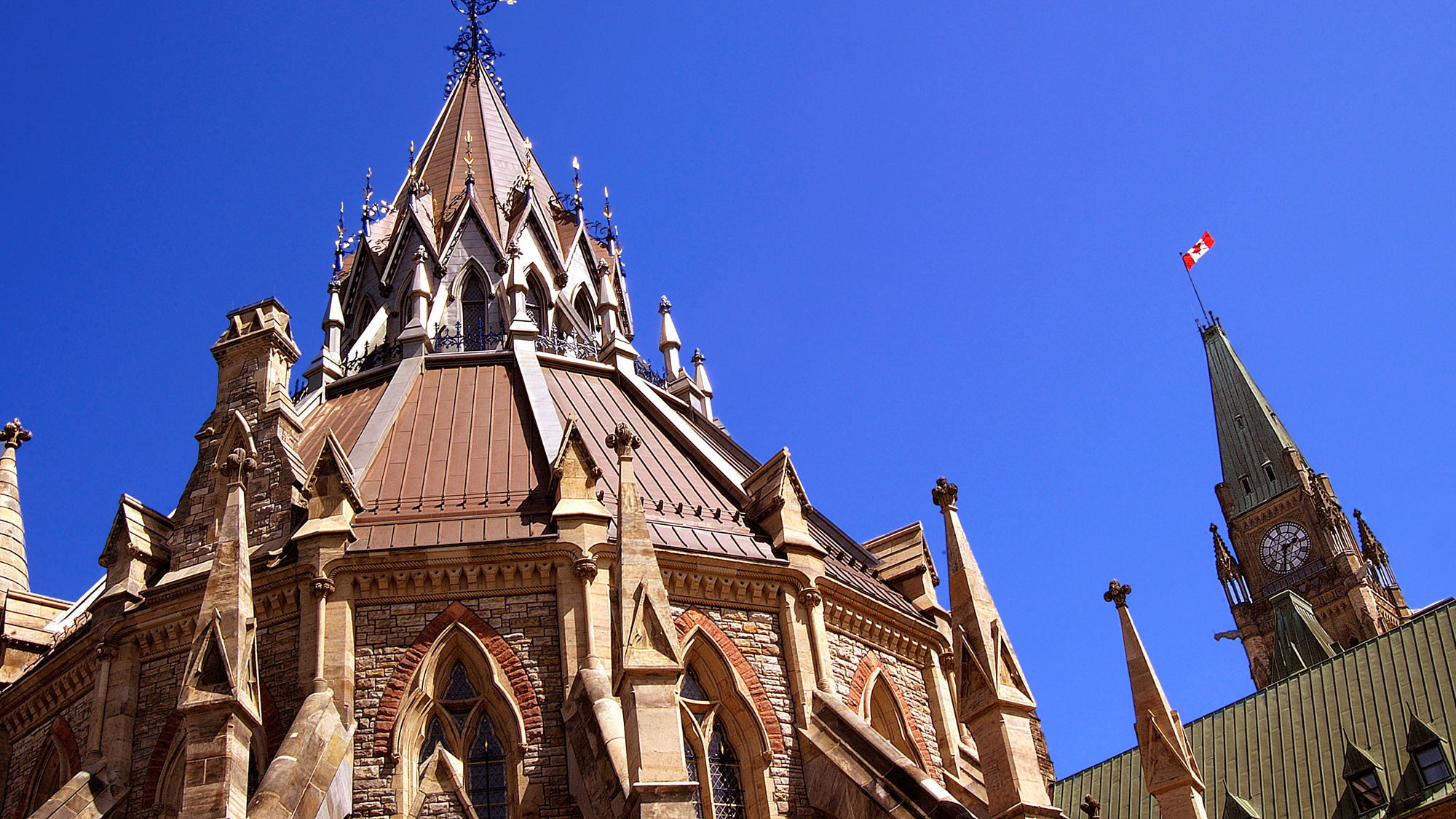 Exterior view of the Library of Parliament with the Peace Tower visible in the background.